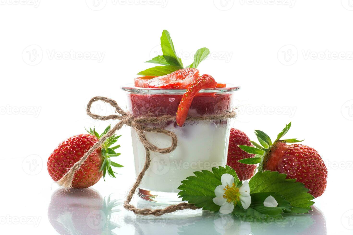 sweet homemade yogurt with strawberry jam and fresh strawberries in a glass cup photo