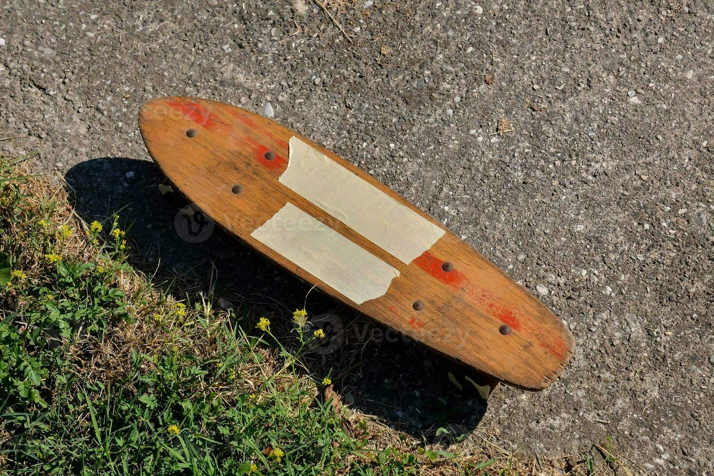 a skateboard with a wooden board on the ground photo