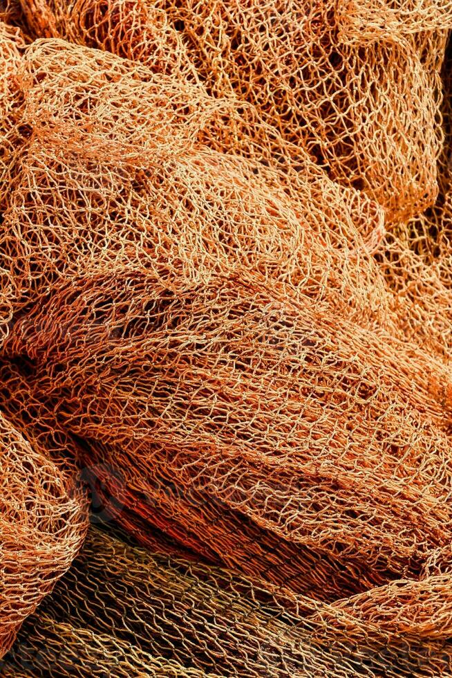 a pile of orange fishing nets photo