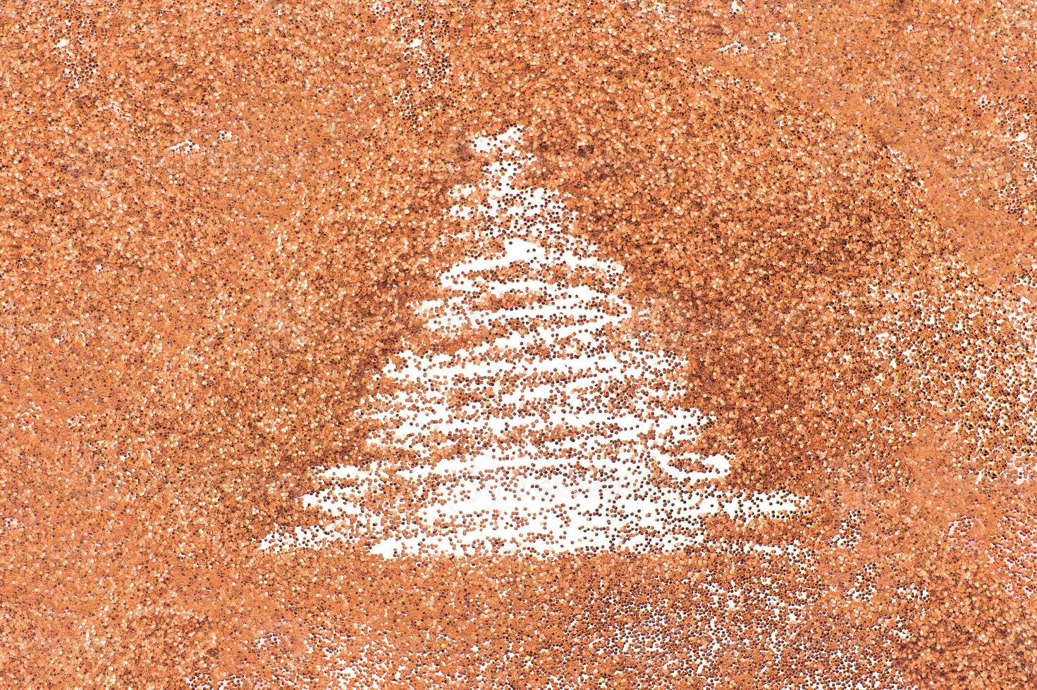 finger drawn christmas tree on shiny Peach Fuzz confetti background photo