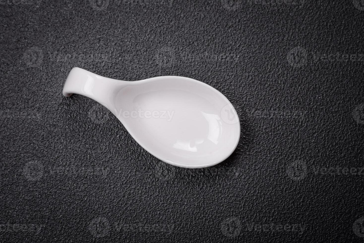 Beautiful empty white ceramic gravy boat on a textured concrete background photo