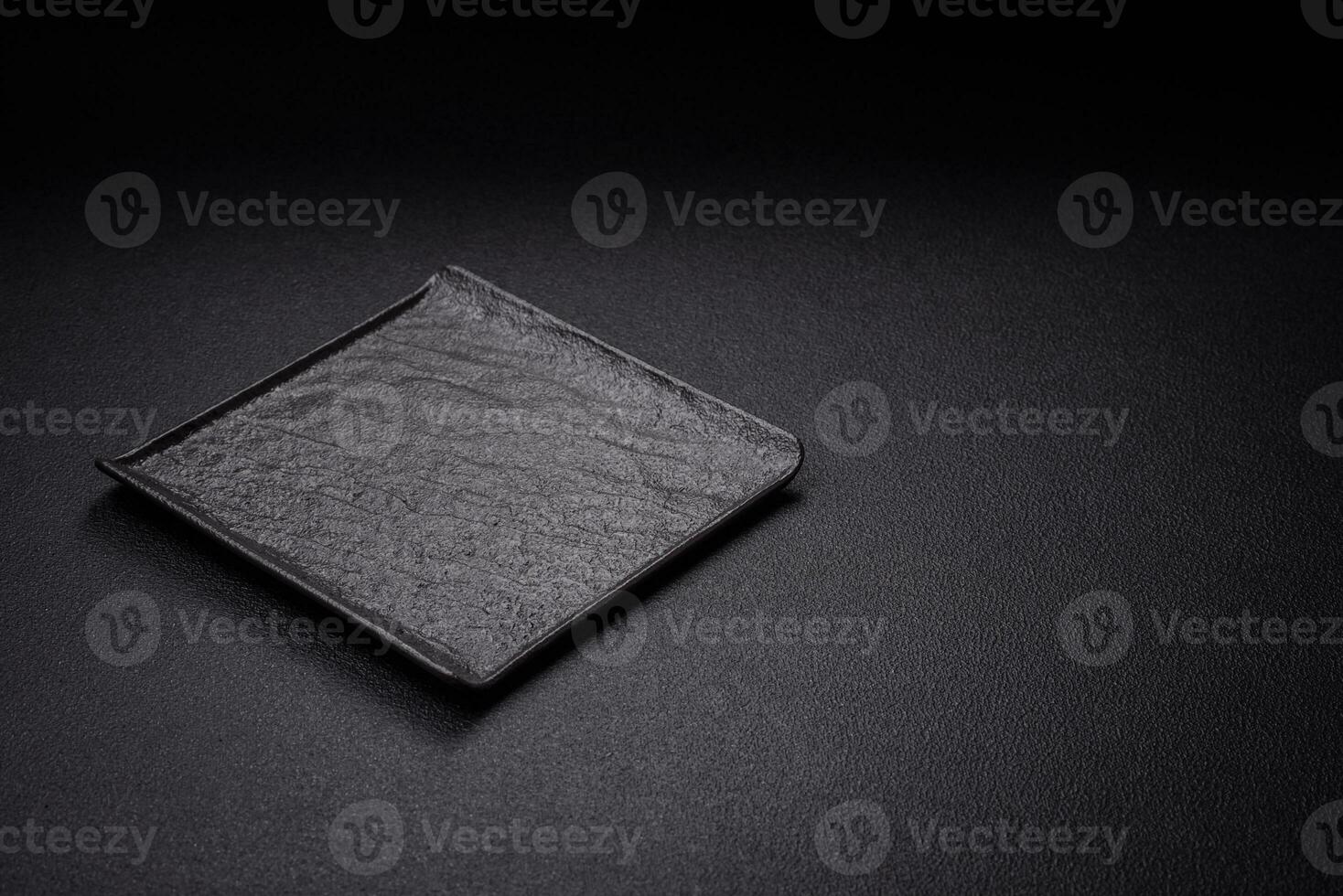 Square empty ceramic plate on textured concrete background photo
