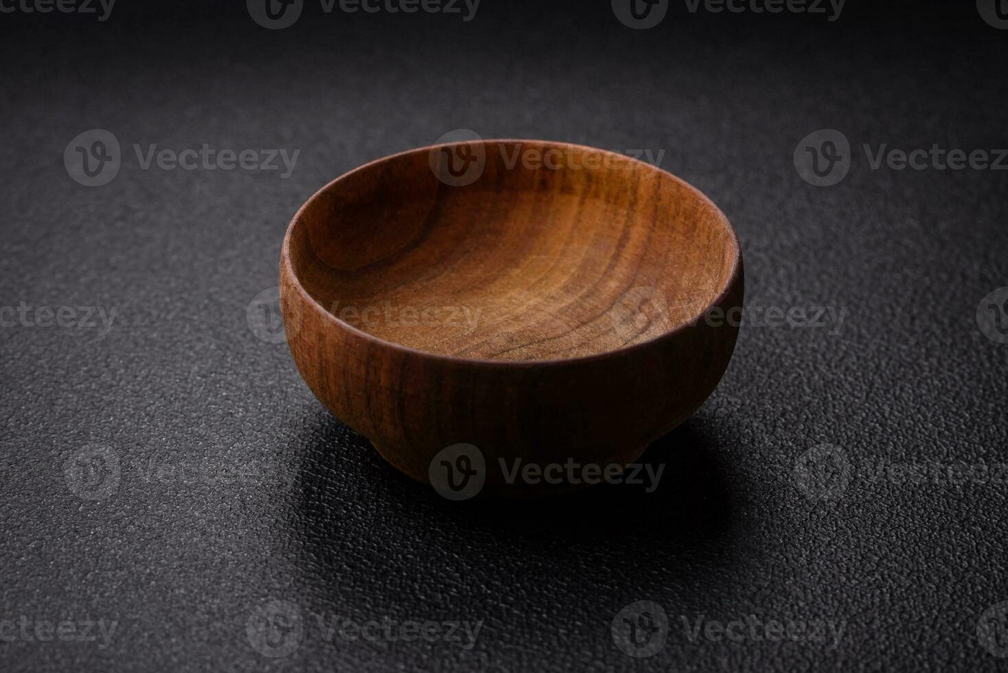 A cylindrical empty container made of wood for spices or salt photo