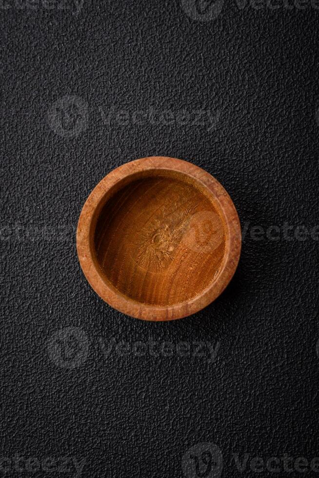A cylindrical empty container made of wood for spices or salt photo