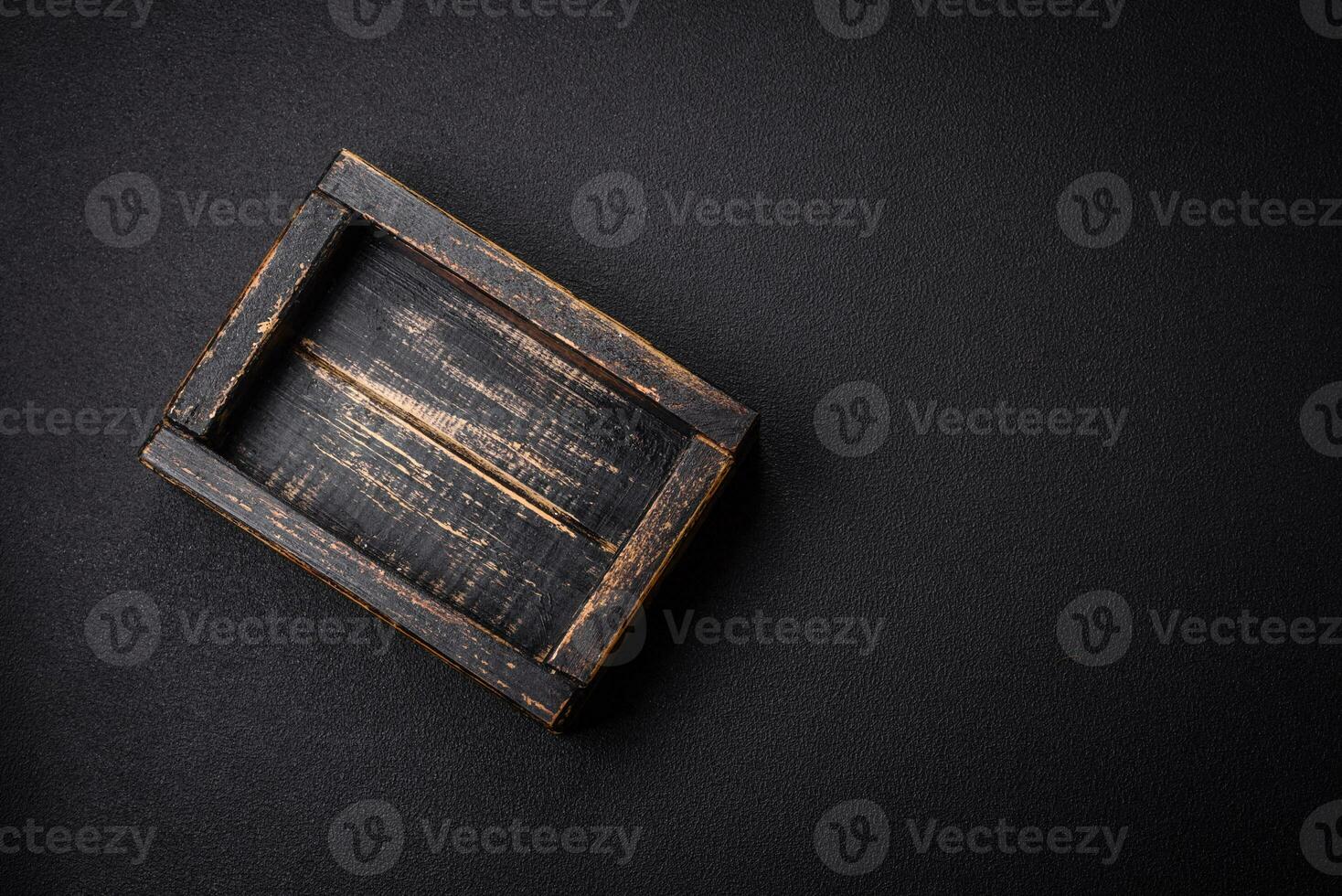 Empty rectangular wooden cutlery box on textured concrete background photo