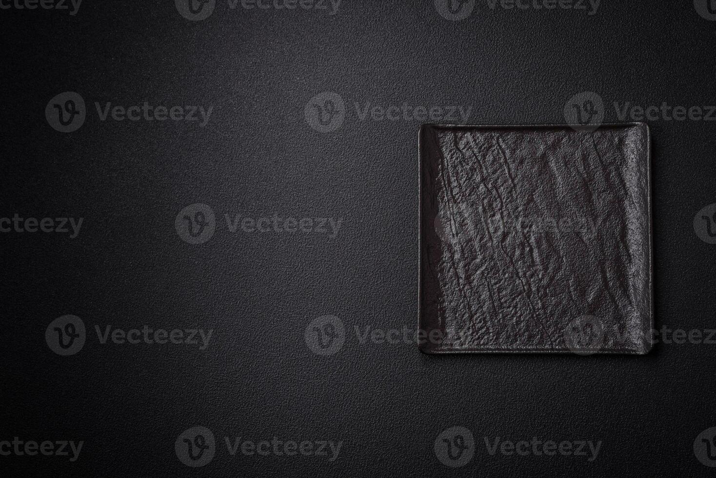 Square empty ceramic plate on textured concrete background photo