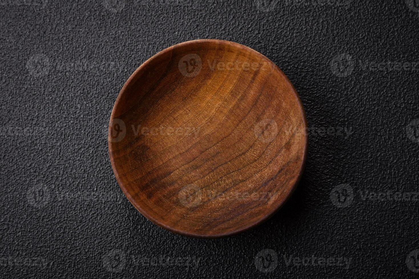 A cylindrical empty container made of wood for spices or salt photo