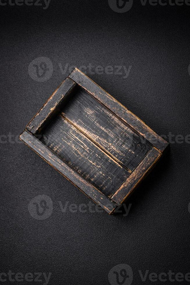 Empty rectangular wooden cutlery box on textured concrete background photo