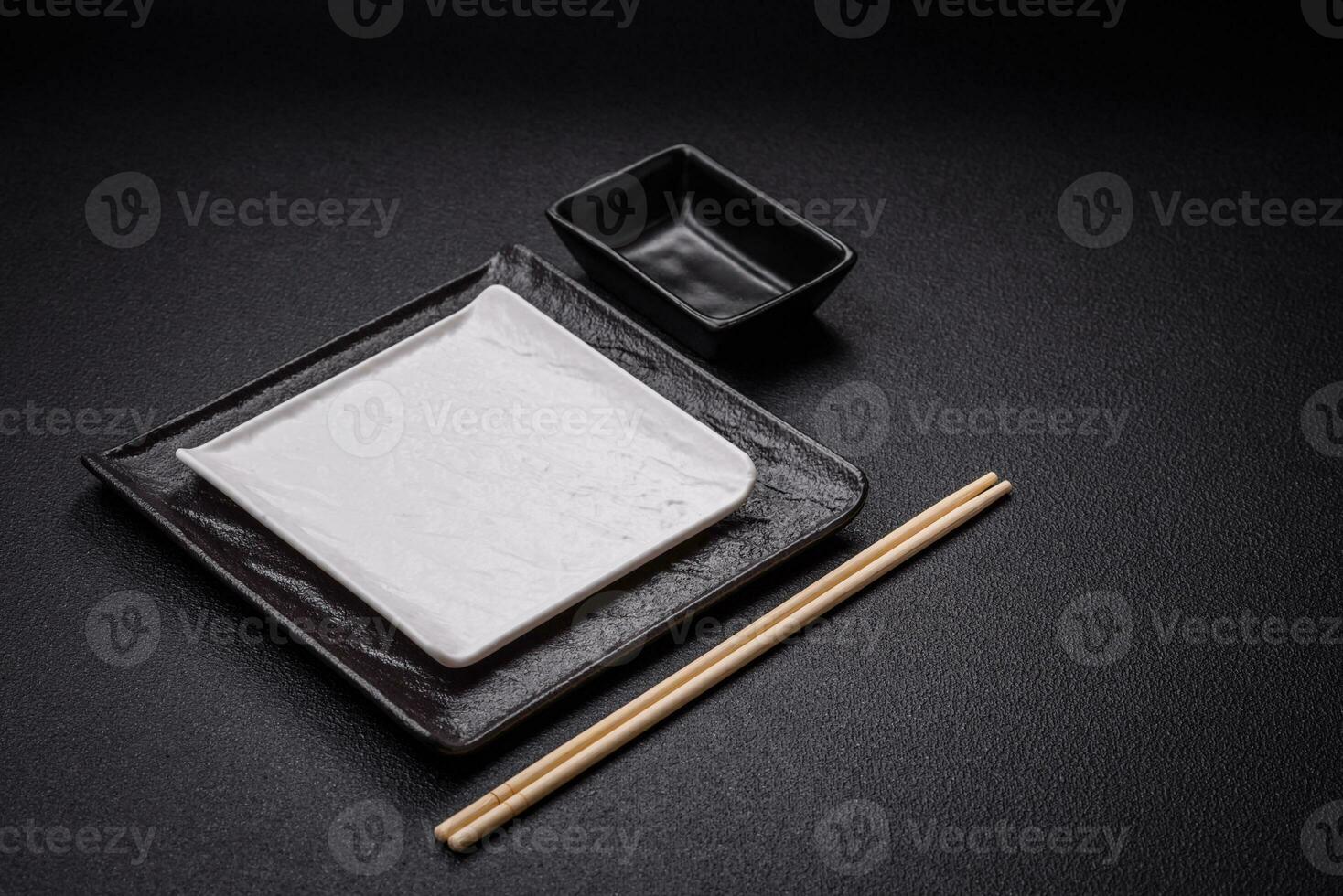 Square empty ceramic plate on textured concrete background photo