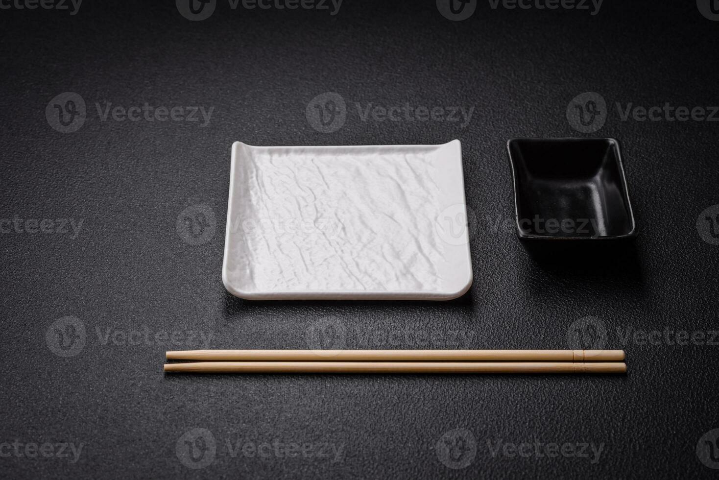 Square empty ceramic plate on textured concrete background photo