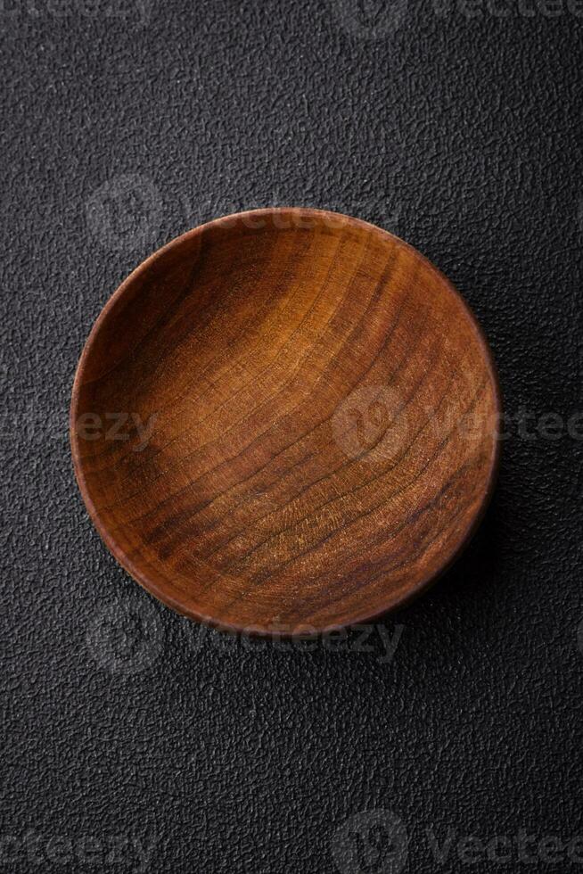A cylindrical empty container made of wood for spices or salt photo