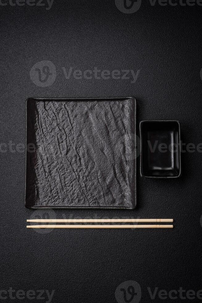 Square empty ceramic plate on textured concrete background photo