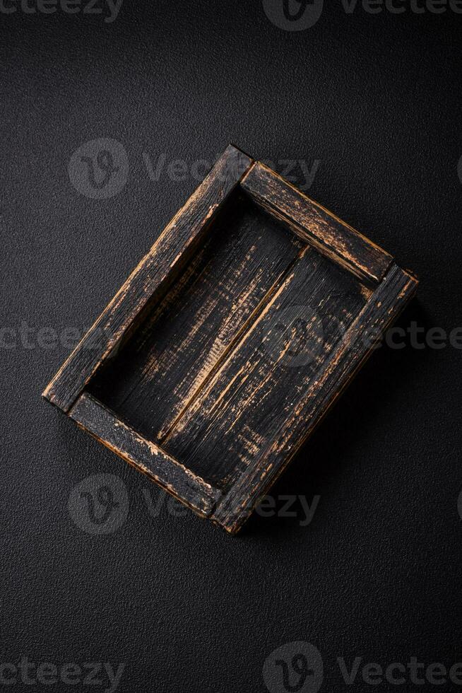 Empty rectangular wooden cutlery box on textured concrete background photo