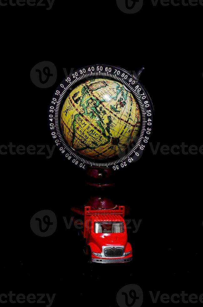 a red truck and a globe on a black background photo
