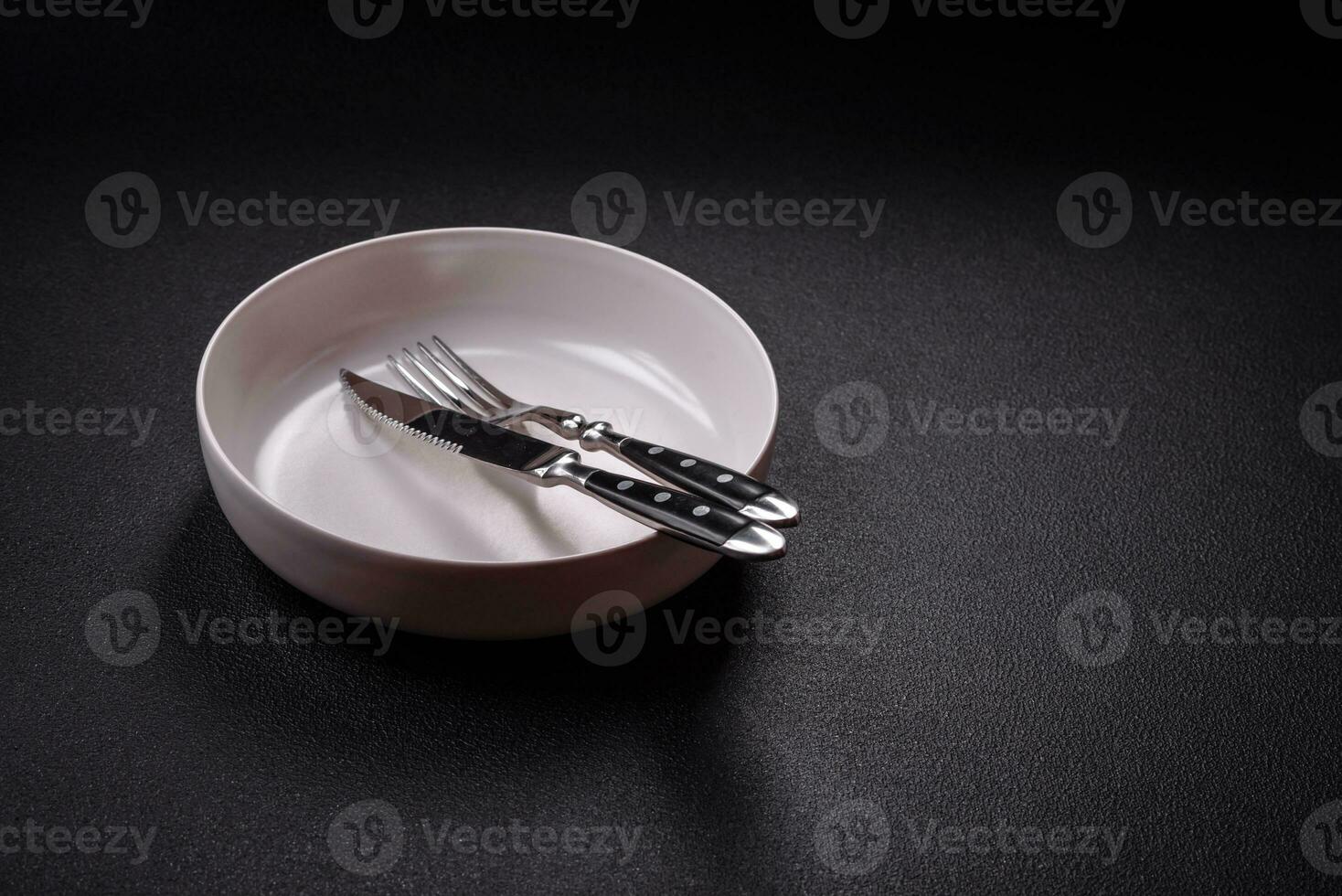 Bumpy empty ceramic plate on a textured concrete background photo