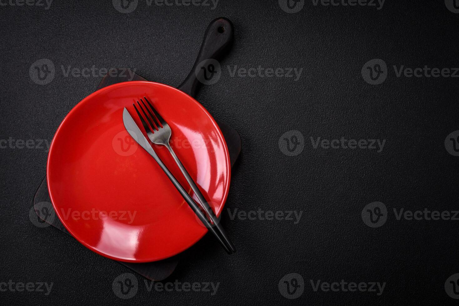 Bumpy empty ceramic plate on a textured concrete background photo