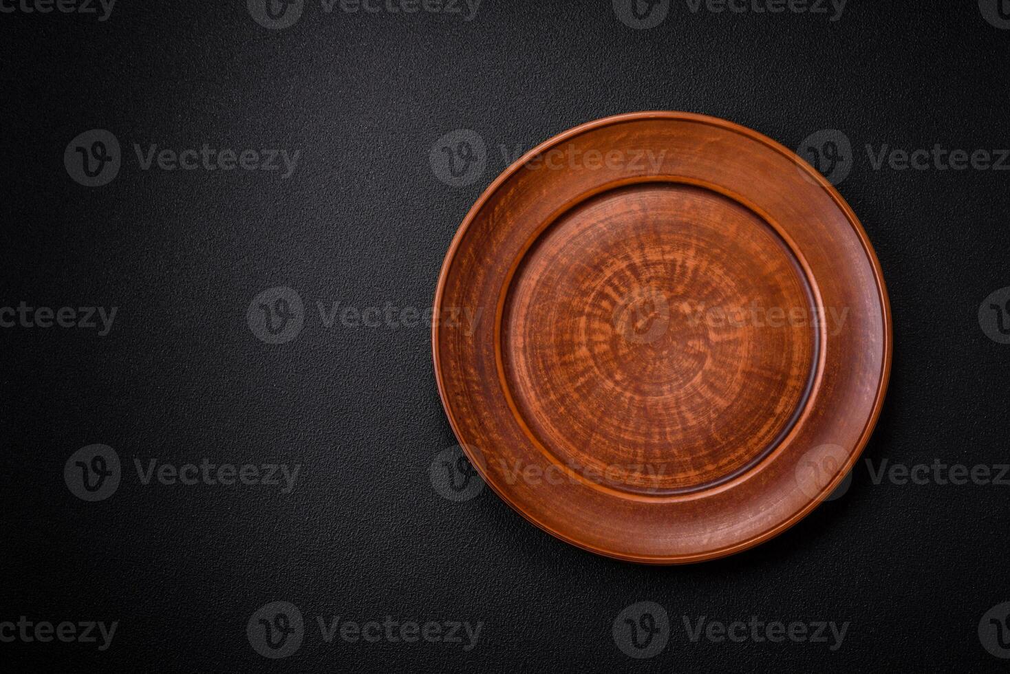 Bumpy empty ceramic plate on a textured concrete background photo