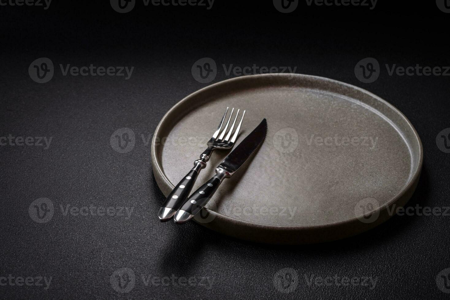 Bumpy empty ceramic plate on a textured concrete background photo