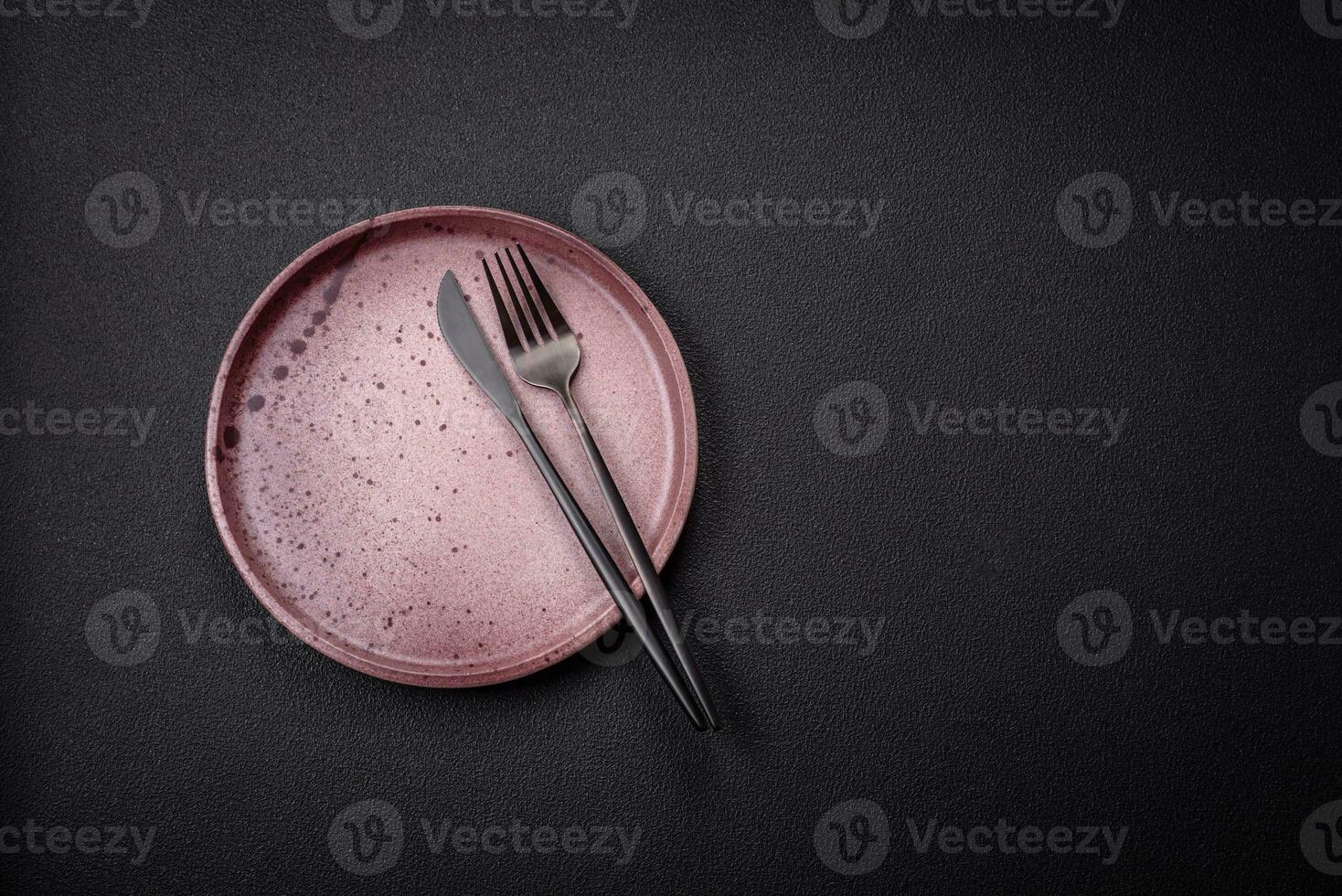 Bumpy empty ceramic plate on a textured concrete background photo