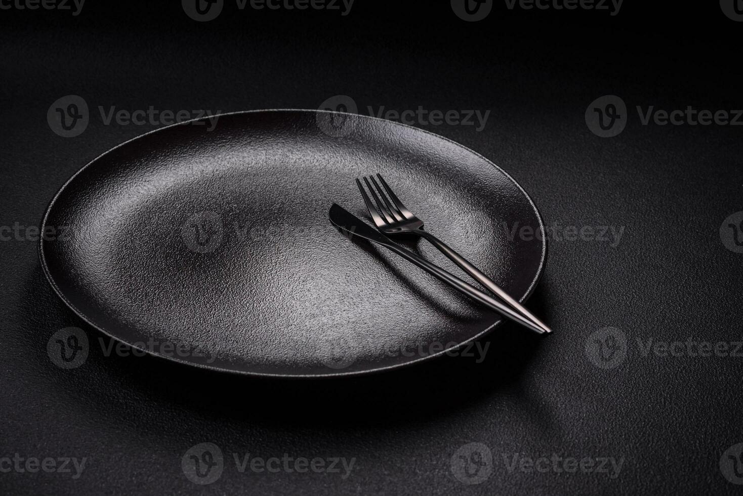 Bumpy empty ceramic plate on a textured concrete background photo