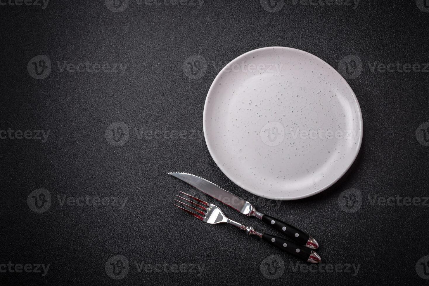 Bumpy empty ceramic plate on a textured concrete background photo