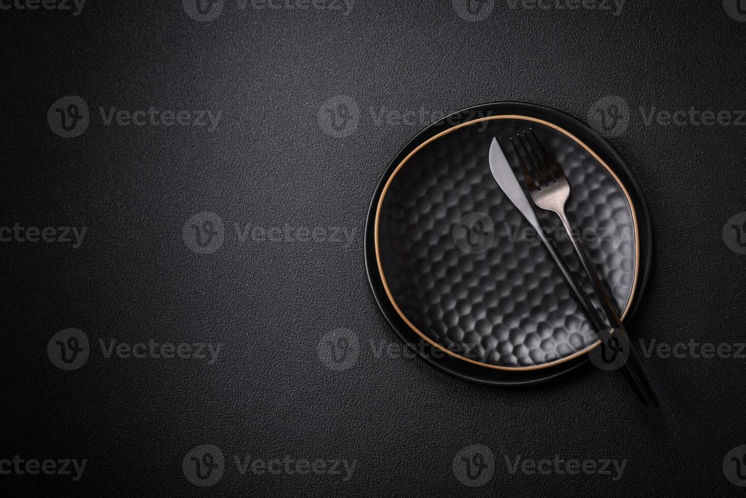 Bumpy empty ceramic plate on a textured concrete background photo