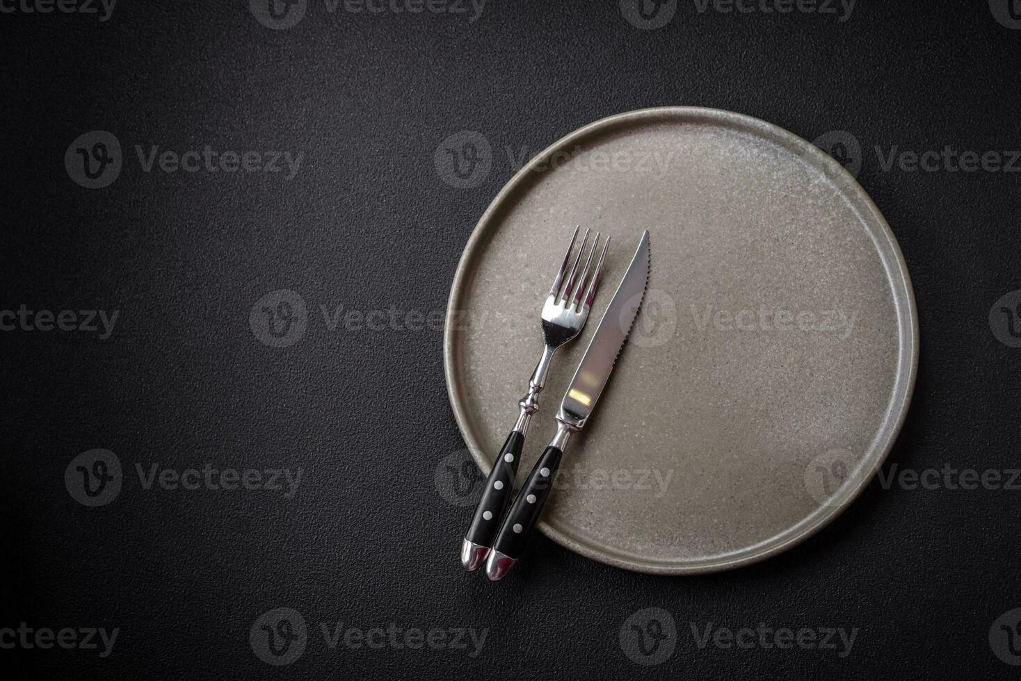 Bumpy empty ceramic plate on a textured concrete background photo