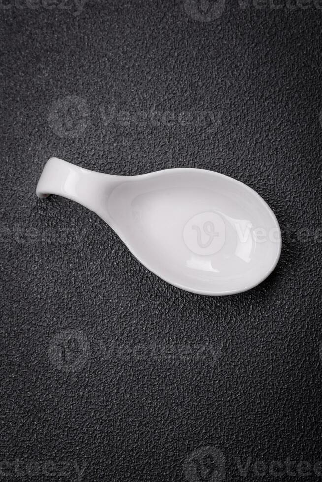 Beautiful empty white ceramic gravy boat on a textured concrete background photo