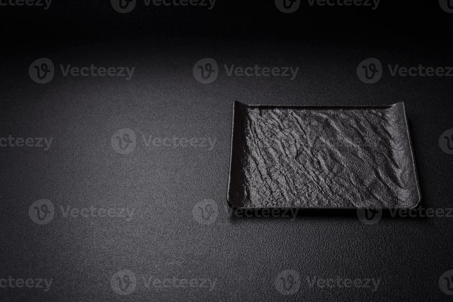 Square empty ceramic plate on textured concrete background photo