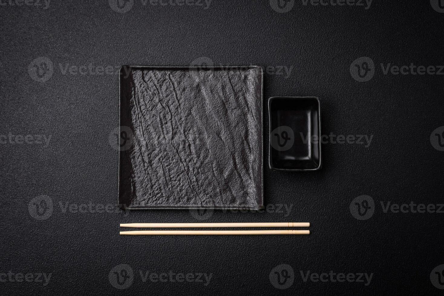 Square empty ceramic plate on textured concrete background photo