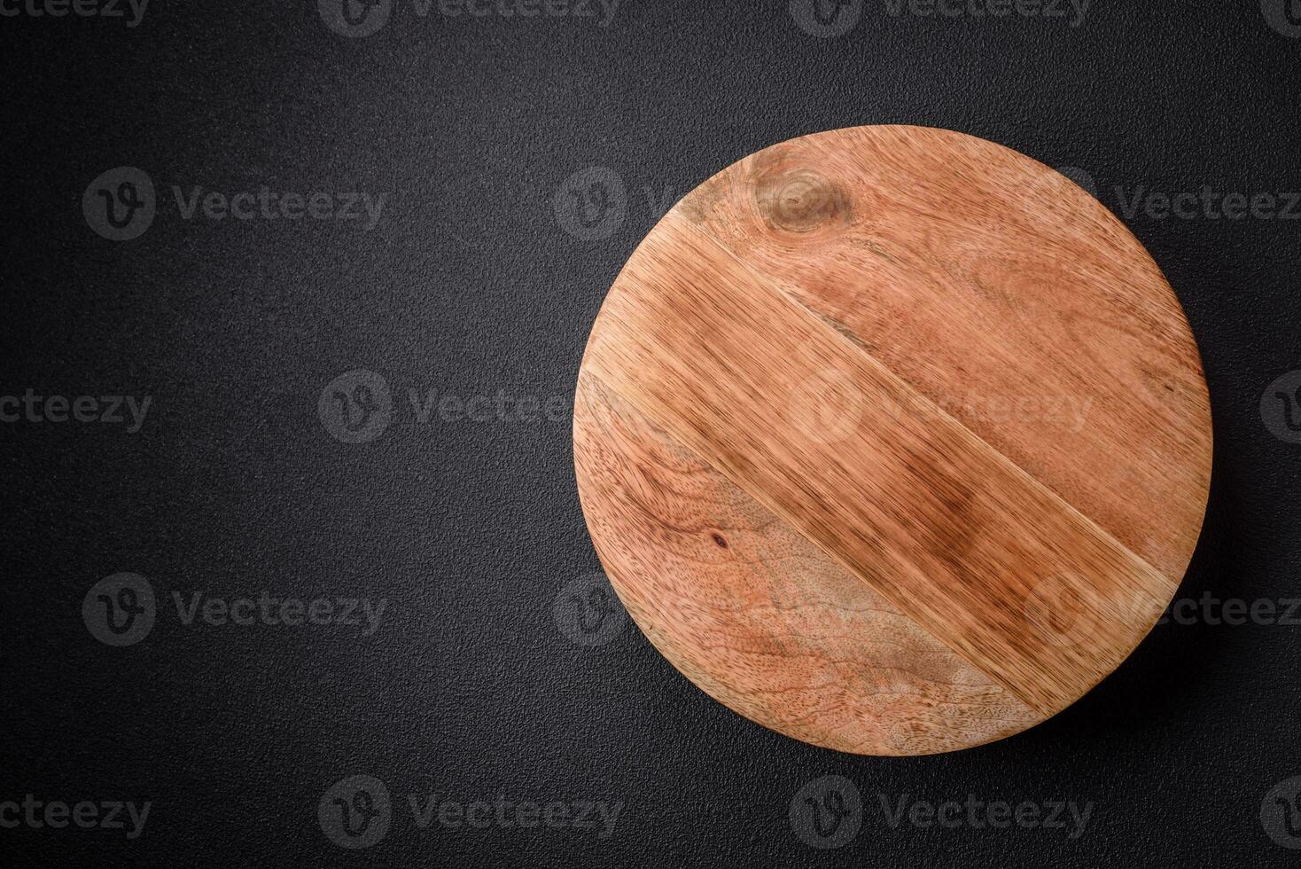 Beautiful round wooden cake stand on a textured concrete background photo