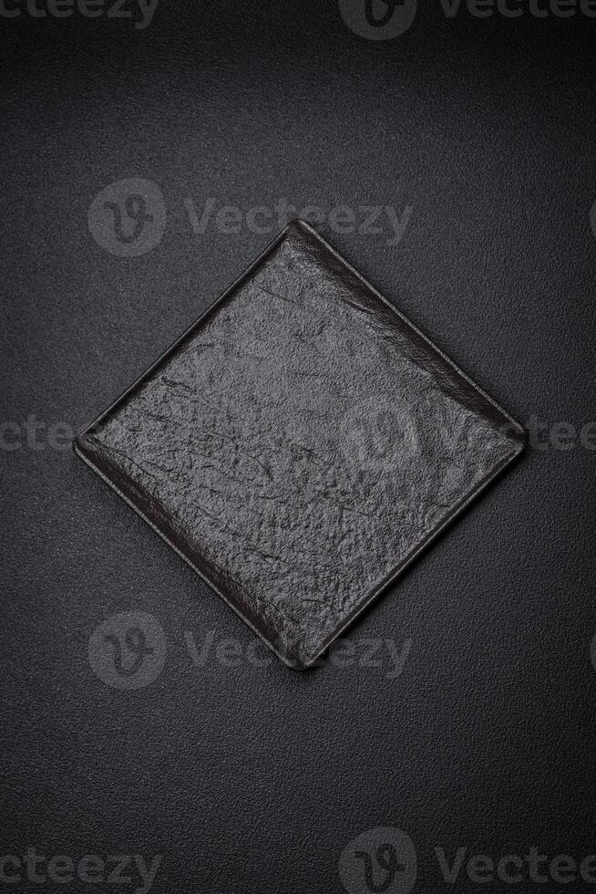 Square empty ceramic plate on textured concrete background photo
