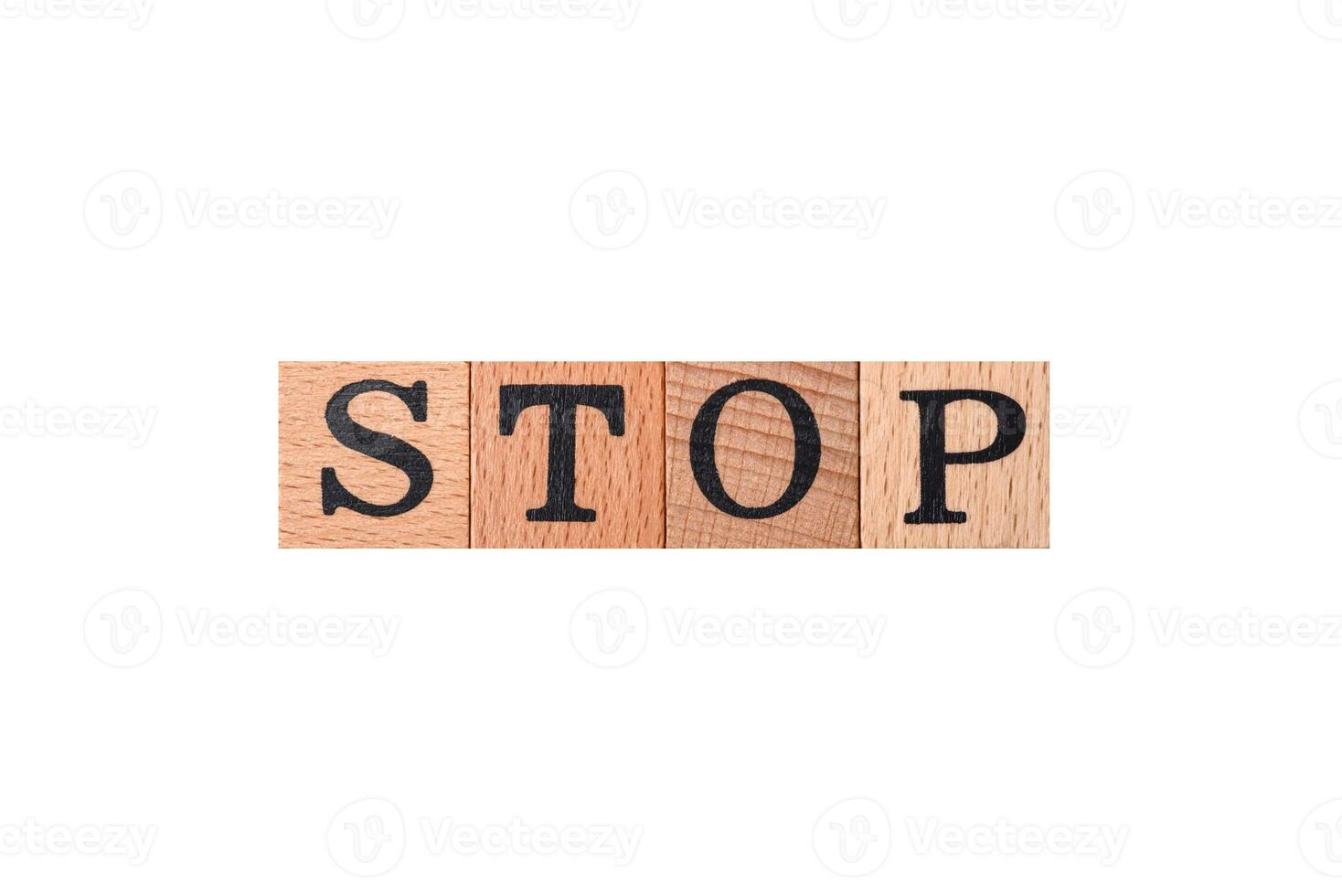The inscription stop on wooden cubes on a dark concrete background photo