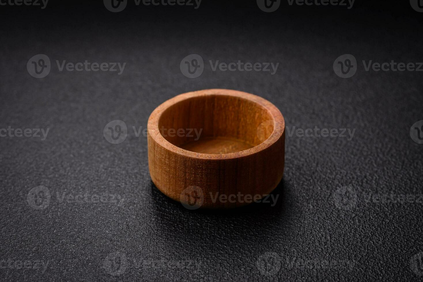 A cylindrical empty container made of wood for spices or salt photo