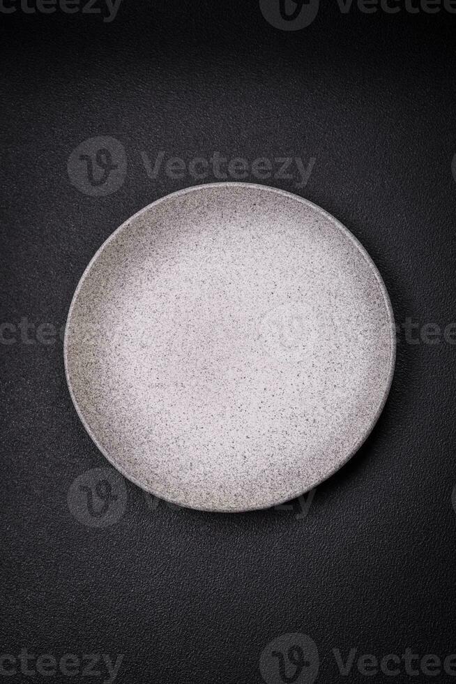 Empty round ceramic plate as an item of kitchen utensils photo