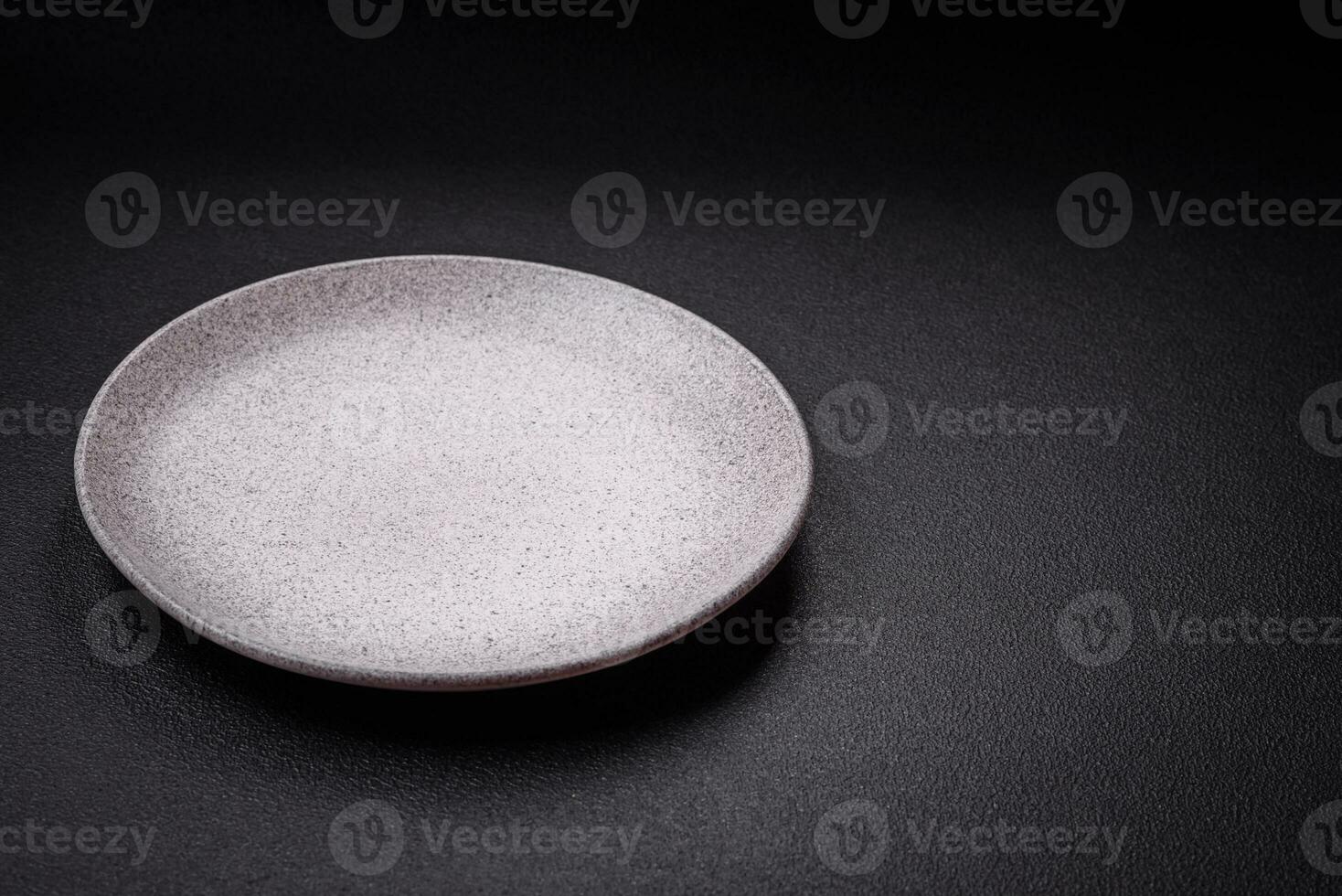 Empty round ceramic plate as an item of kitchen utensils photo