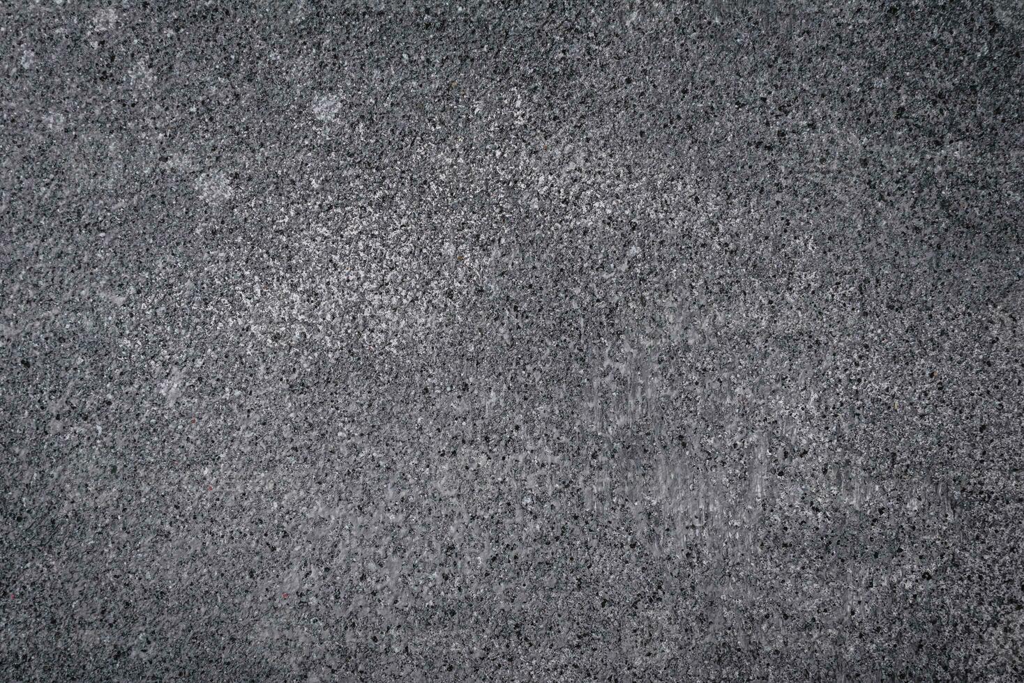 Texture of a concrete wall with cracks and scratches which can be used as a background photo