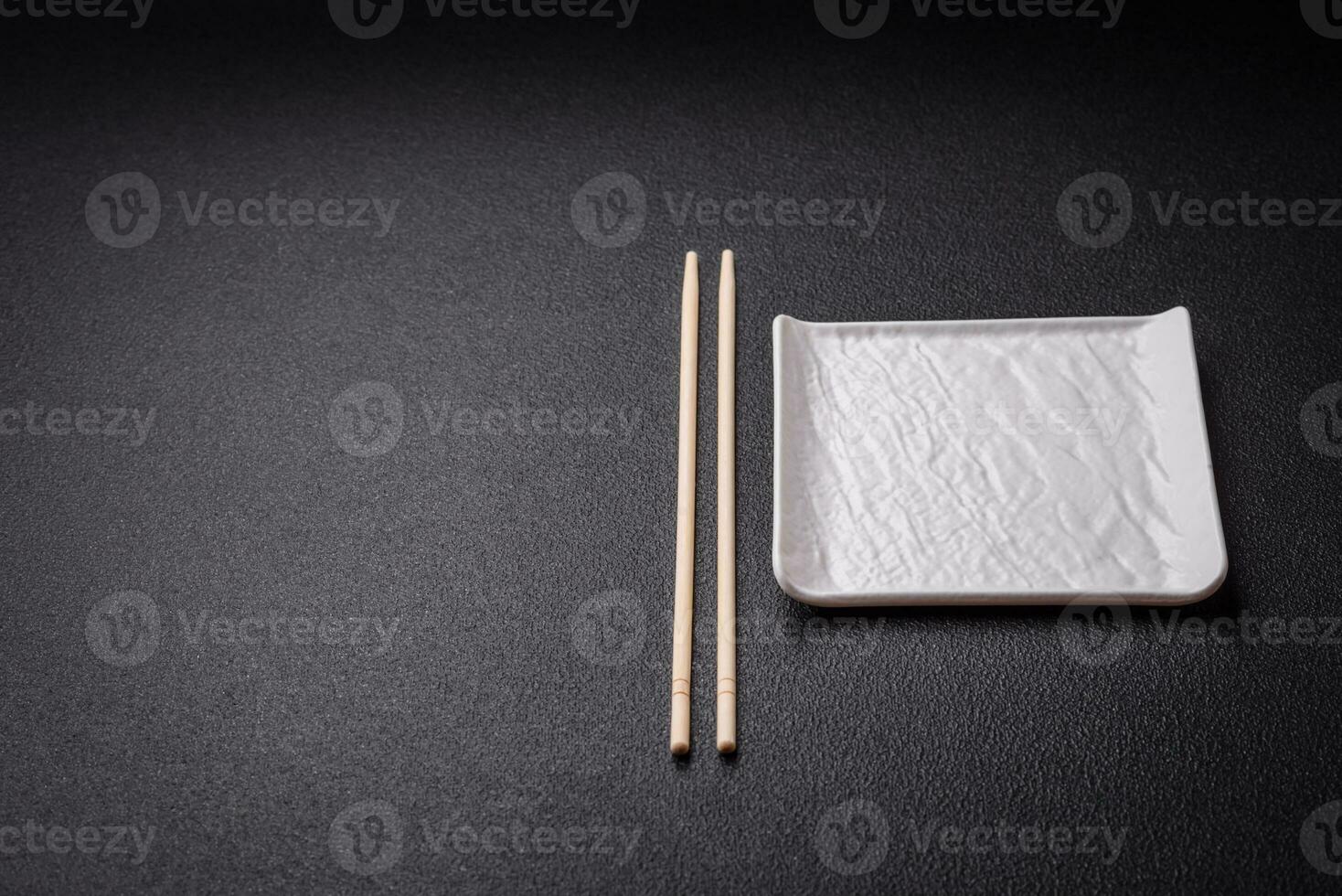 Square empty ceramic plate on textured concrete background photo