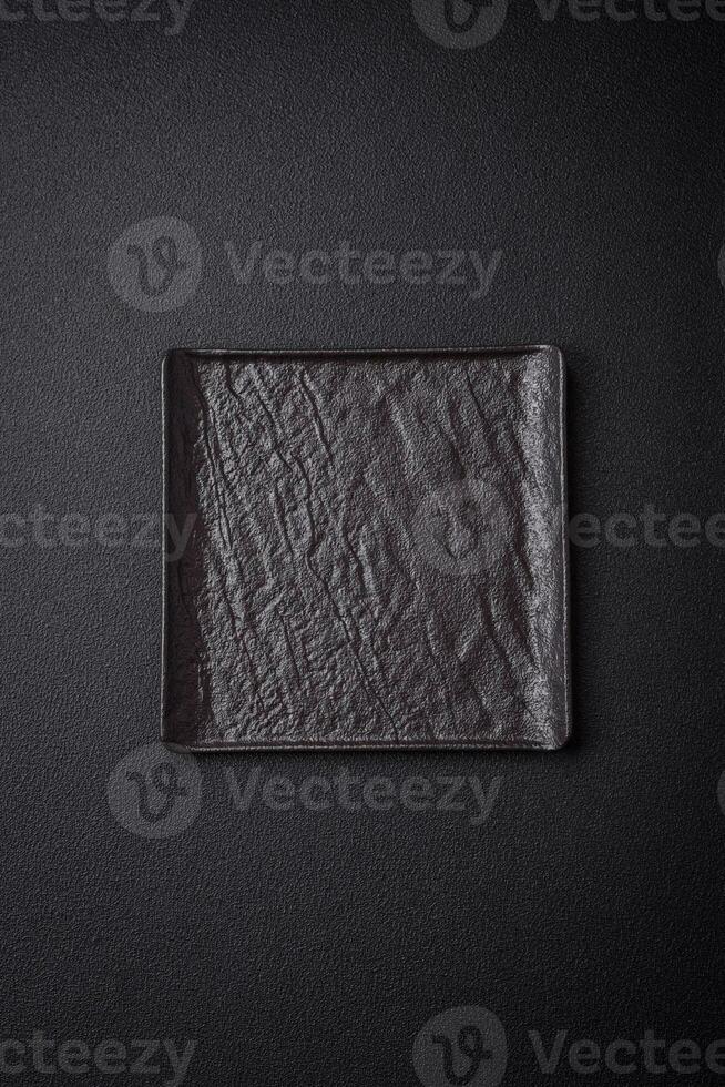 Square empty ceramic plate on textured concrete background photo