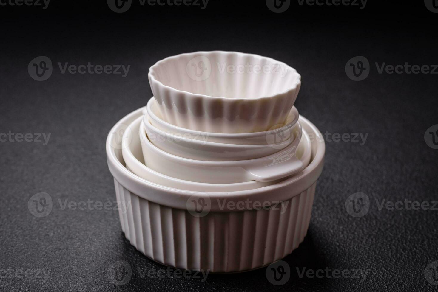 Beautiful empty white ceramic gravy boat on a textured concrete background photo