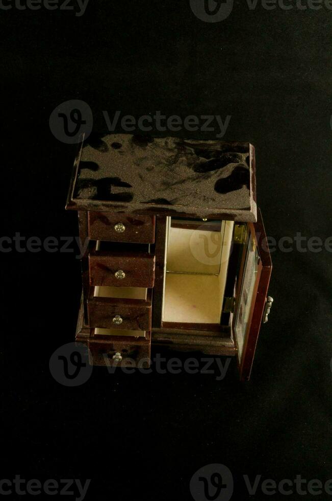 a small wooden jewelry box with drawers photo