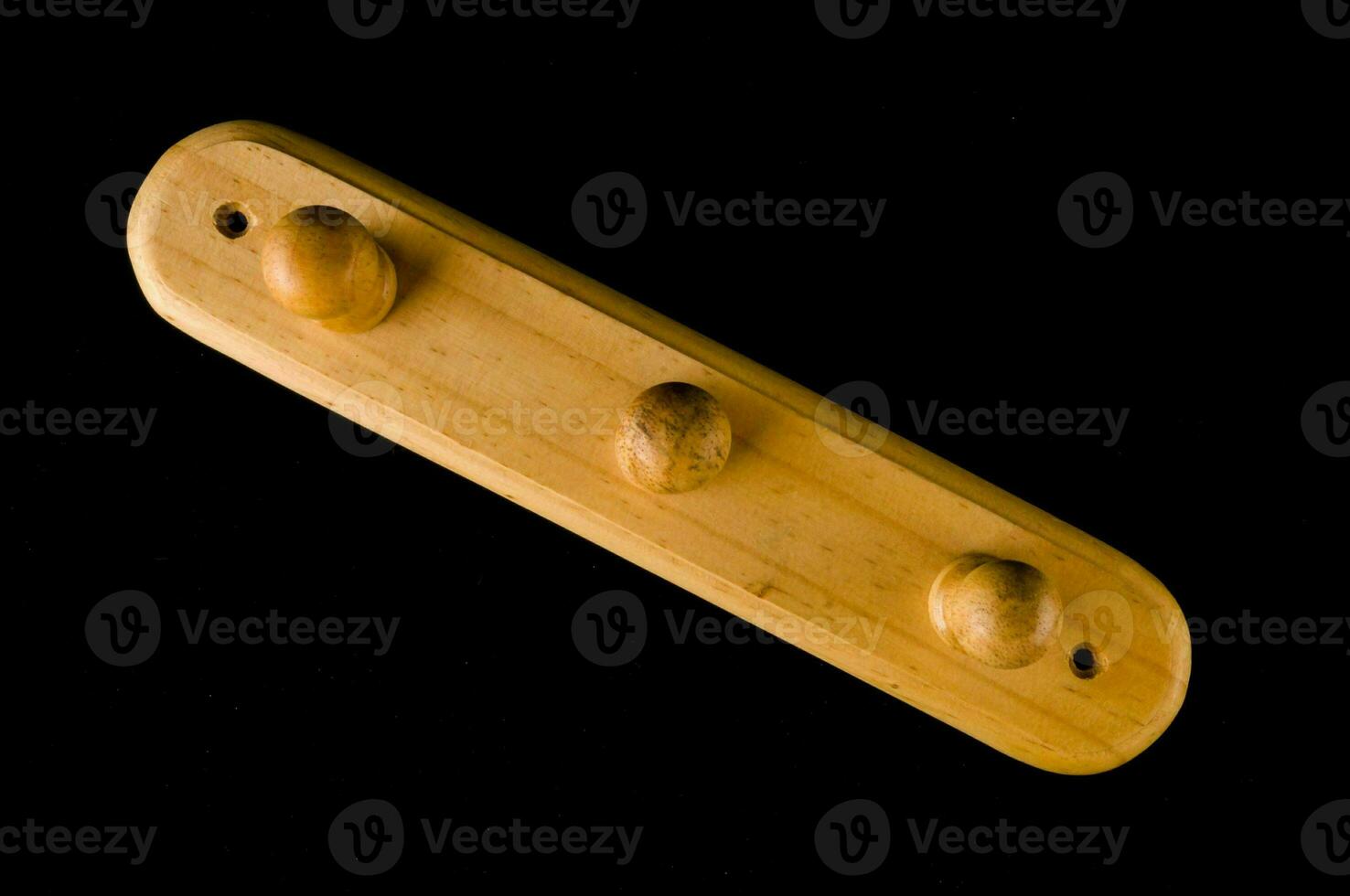 a wooden coat rack with four holes photo