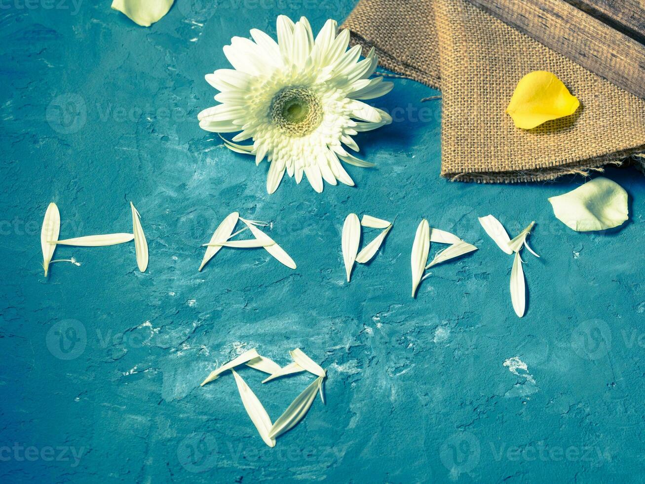 Word happy written with petals photo