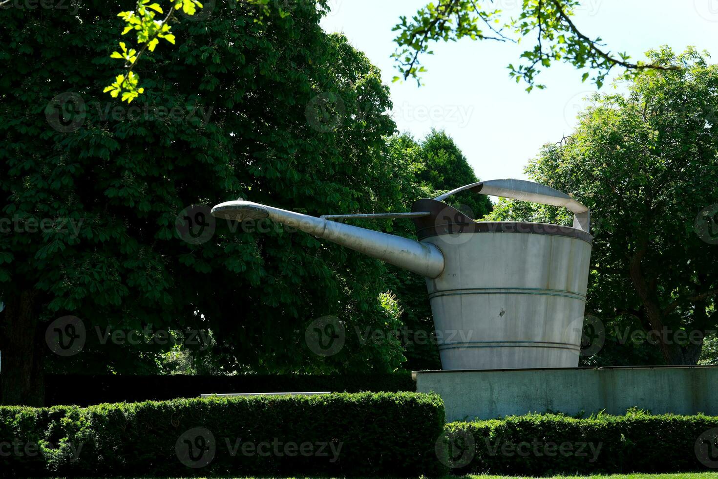 statue in the form of a huge watering can watering the garden Beacon Hill park Victoria Canada BC photo