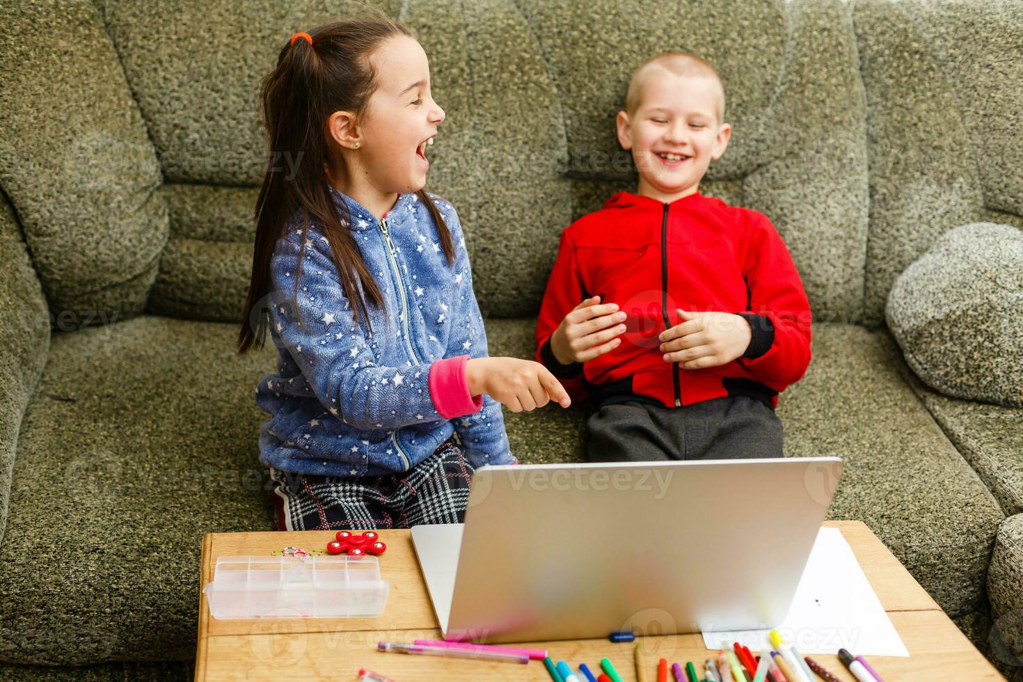Distance learning online education. school boy and girl studying at home with laptop notebook and doing homework. Sitting at a table photo