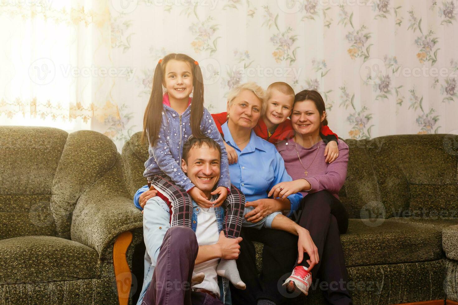 Grown up adult smiling grandchildren embraces elderly grandmother glad to see missing her, visit of loving relatives enjoy communication, cuddle as symbol of connection, love and support concept photo