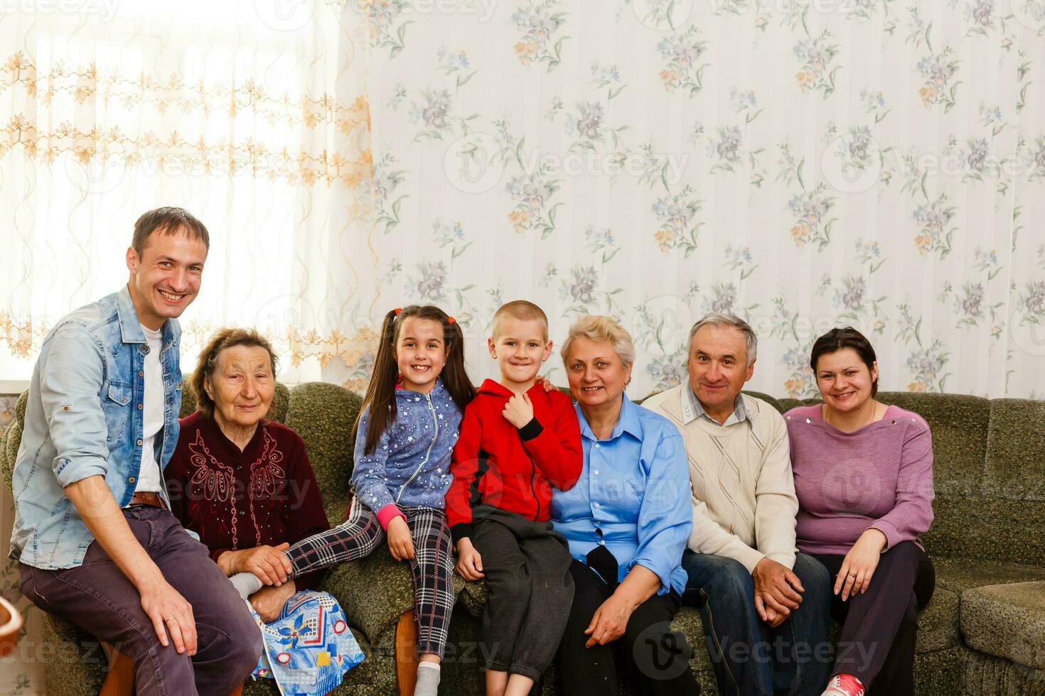 Happy big family on the sofa at home photo