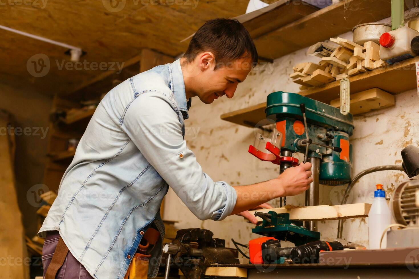 Carpenter works in a workshop for the production of vintage furniture photo