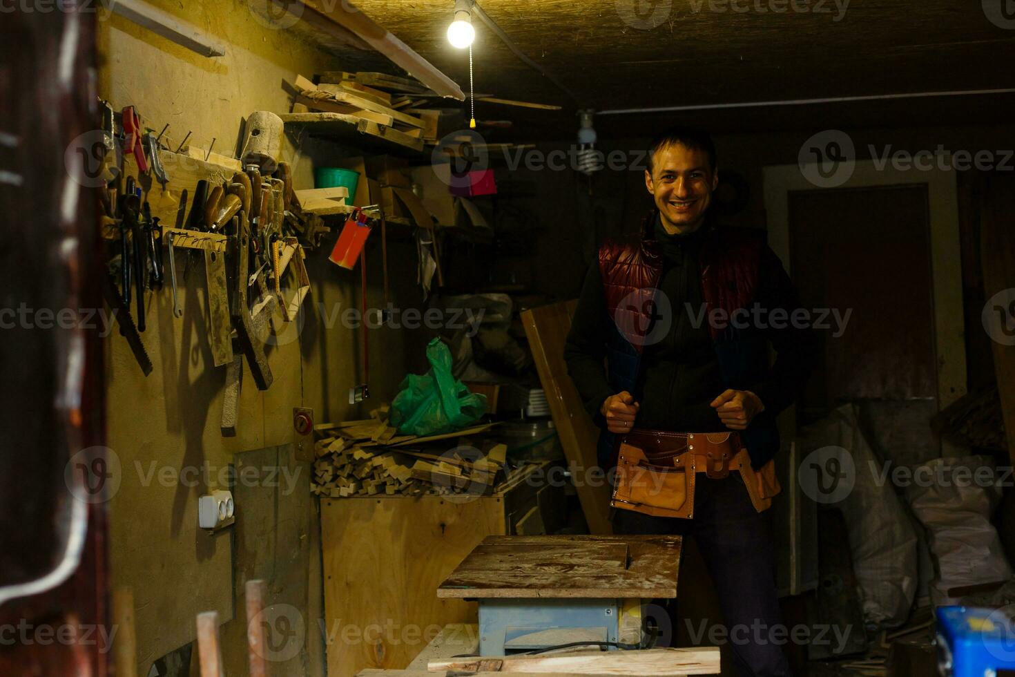 handsome joiner work in carpentry. He is successful entrepreneur at his workplace. photo