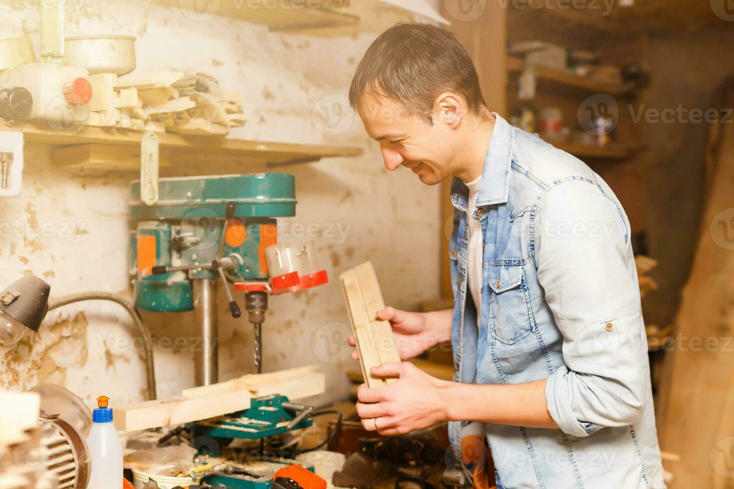 Carpenter works in a workshop for the production of vintage furniture photo